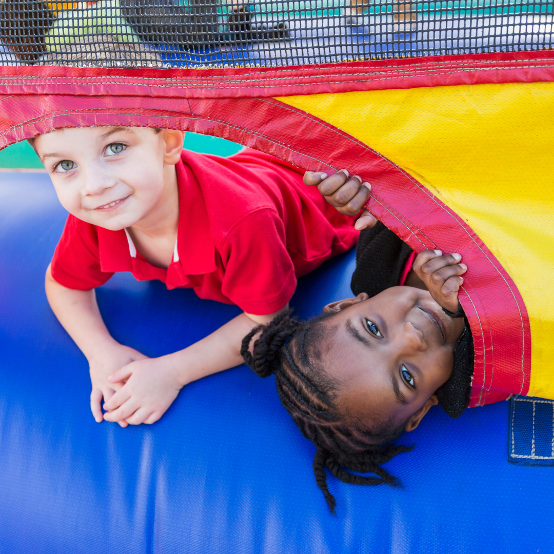 Children having fun in a colorful bounce house rental at a backyard birthday party in Dallas, Georgia