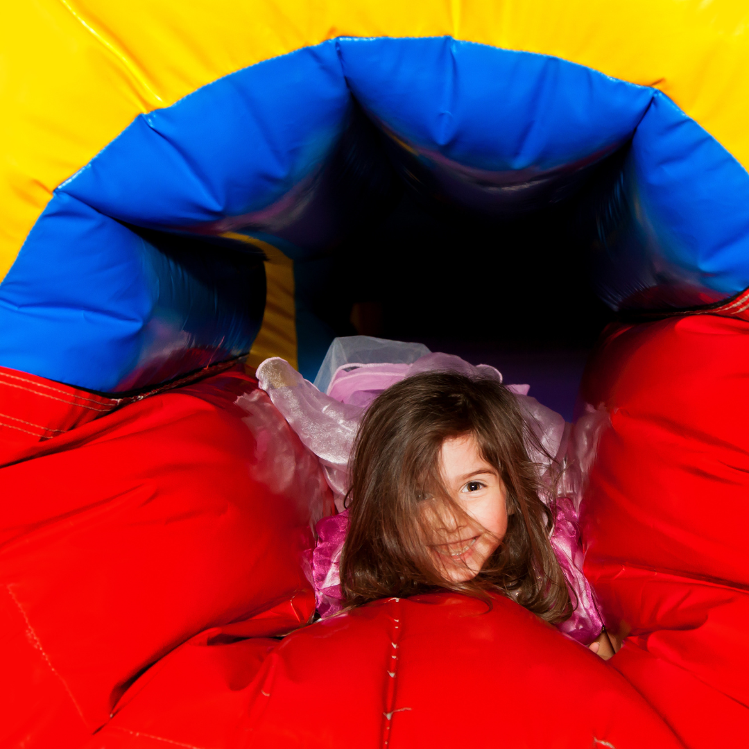 Colorful bounce house combo with slides set up for a children's birthday party in Dallas, Georgia